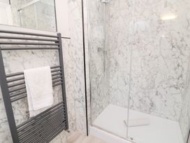 A bathroom with a shower and towel rail at Fairways in Woolacombe