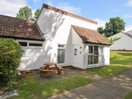 A house with a table and chairs outside at Manorcombe 2 in Callington