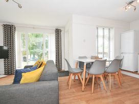 A living room with a sofa and dining area at Manorcombe 2 in Callington