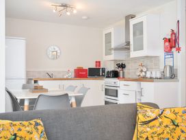 A kitchen with appliances and a dining area at Manorcombe 2 in Callington