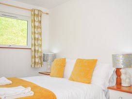 A bedroom with a bed and lamps at Manorcombe 2 Callington