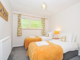 A bedroom with two beds and window at Manorcombe 2 Callington