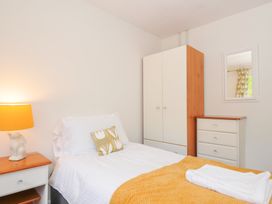 A bedroom with a bed and a lamp at Manorcombe 2 Callington