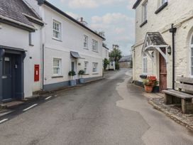 A street with buildings, a post box and a bench at Trelan Mevagissey