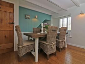 A dining room with a table and chairs at Trelan in Mevagissey