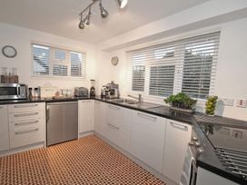 A kitchen with modern appliances and a stove at Trelan in Mevagissey