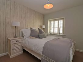 A bedroom with a bed and bedside table at Trelan in Mevagissey