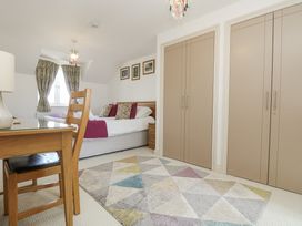 A bedroom with a bed and desk at Ridgeback House in Mullion