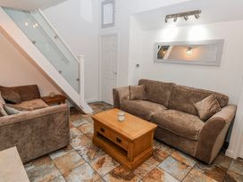 A living room with sofa and coffee table at Trelessy Lodge Llanteg near Amroth