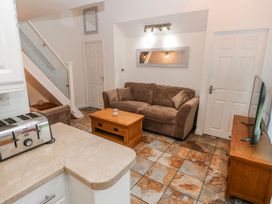 A living room with a sofa and television at Trelessy Lodge in Llanteg near Amroth