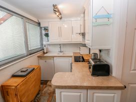 A kitchen with sink and appliances at Trelessy Lodge Llanteg near Amroth