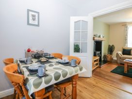 A dining room with a table and chairs at Bythynnod Newydd in Trefor near Nefyn