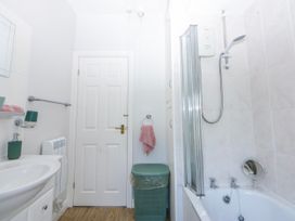 A bathroom with a sink, shower, and bathtub at Bythynnod Newydd Trefor near Nefyn
