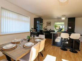 A kitchen with a dining area featuring a table set at Blacksmiths Cottage in Shilbottle