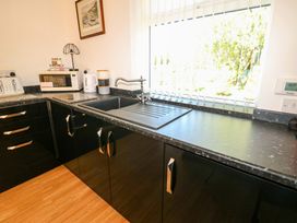 A kitchen with a sink and countertop at Blacksmiths Cottage in Shilbottle