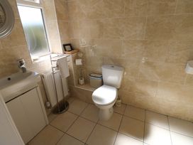 A bathroom with a toilet and sink at Blacksmiths Cottage in Shilbottle