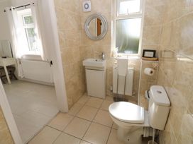 A bathroom with a sink and toilet at Blacksmiths Cottage in Shilbottle