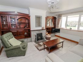 A living room with a fireplace, coffee table, and sofa at Castle View, Oughterard, County Galway