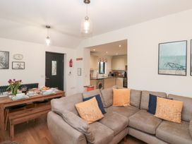 A living room with a sofa and dining table at Fieldside in Hunmanby