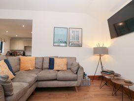 A living room with a sofa and television at Fieldside in Hunmanby