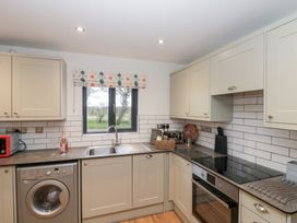 A kitchen with a sink and oven at Fieldside in Hunmanby