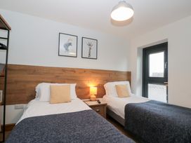 A bedroom with twin beds and a nightstand at Fieldside in Hunmanby