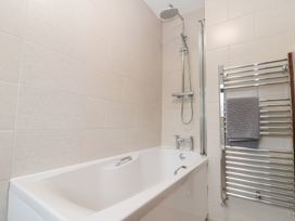 A bathroom with a bathtub and shower at Fieldside in Hunmanby