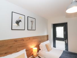 A bedroom with two beds and artwork on the wall at Fieldside in Hunmanby