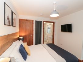 A bedroom with a bed and wall art at Fieldside in Hunmanby