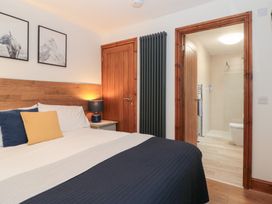 A bedroom with a bed and access to a bathroom at Fieldside in Hunmanby