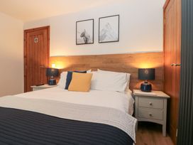 A bedroom with a bed and nightstands at Fieldside in Hunmanby