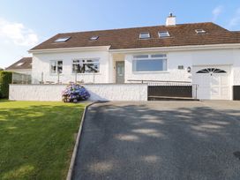 A house with a garage and garden at Bay View in Benllech