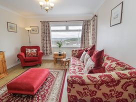 A living room with a sofa and armchair at Bay View in Benllech