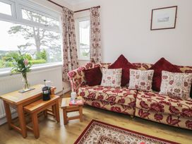 A living room with a floral sofa and coffee table at Bay View in Benllech