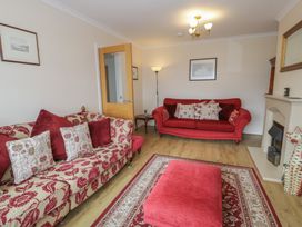A living room with two sofas and a coffee table at Bay View in Benllech