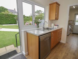 A kitchen with a sink and dishwasher at Bay View Benllech