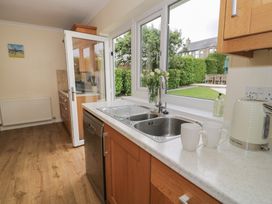 A kitchen with a sink and dishwasher at Bay View in Benllech