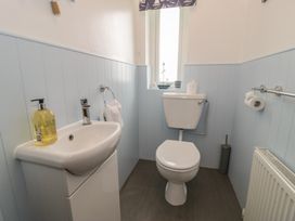 A bathroom with a sink and toilet at Bay View in Benllech