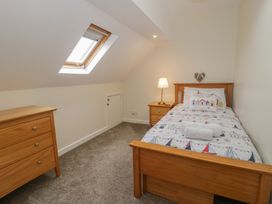 A bedroom with a bed and a chest of drawers at Bay View in Benllech