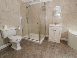 A bathroom with a shower, toilet, sink, and bathtub at Bay View in Benllech
