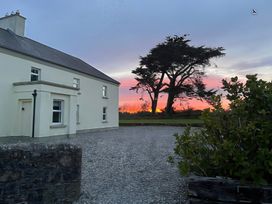A house and tree at sunset at Sanderling Lodge in Tacumshane, County Wexford