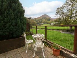 A garden with chairs and a view of a hill at River's Nook in Llangynog