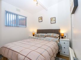 A bedroom with a bed and bedside table at River's Nook in Llangynog