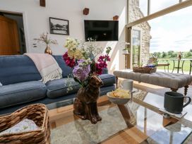 A living room with a sofa and decorative items at Crane Field Laithe Otterburn, North Yorkshire