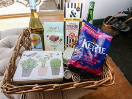 A basket filled with various snacks and drinks at Crane Field Laithe Otterburn North Yorkshire