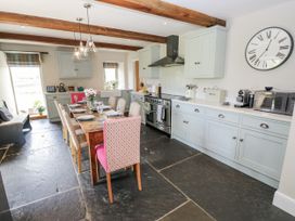 A kitchen with a dining table and chairs at Crane Field Laithe Otterburn, North Yorkshire