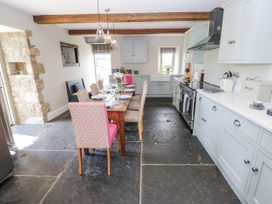A kitchen with a table and chairs at Crane Field Laithe, Otterburn, North Yorkshire