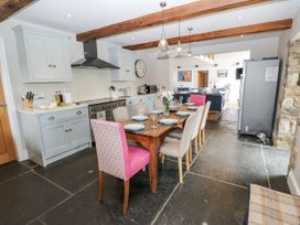 A kitchen with a table set for dining at Crane Field Laithe Otterburn, North Yorkshire