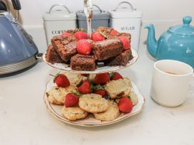 A tiered stand with brownies and scones in a kitchen at Crane Field Laithe Otterburn North Yorkshire