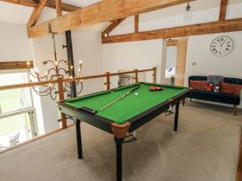A game room featuring a pool table and a couch at Crane Field Laithe in Otterburn, North Yorkshire